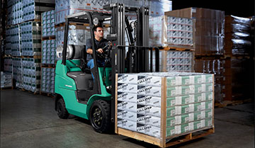 Operator Carrying Merchandise with a Mitsubishi FGC15N Forklift